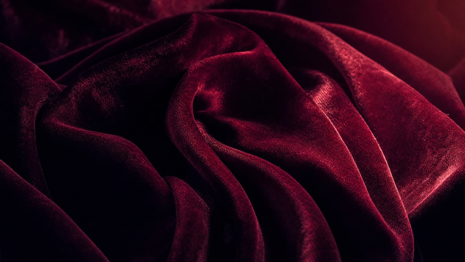 Crimson velvet folds with rose rim light